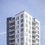 A vertical shot of a white building under the clear sky
